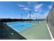 Outdoor tennis courts feature a vibrant blue surface and are surrounded by a green fence at 6524 Summershade St, North Las Vegas, NV 89086