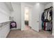 This is a walk-in closet with access to the bathroom, and has lots of shelving at 6524 Summershade St, North Las Vegas, NV 89086