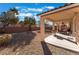 Covered patio, gravel yard, and BBQ grill at 6916 Snow Finch St, North Las Vegas, NV 89084