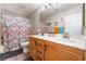Bathroom with double sinks and patterned shower curtain at 6916 Snow Finch St, North Las Vegas, NV 89084