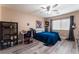 Spacious bedroom with a blue comforter and plenty of storage at 6916 Snow Finch St, North Las Vegas, NV 89084