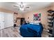 Bedroom with blue comforter and ceiling fan at 6916 Snow Finch St, North Las Vegas, NV 89084