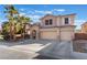 Two-story house with a three-car garage and desert landscaping at 6916 Snow Finch St, North Las Vegas, NV 89084