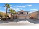 Two-story house with a three-car garage and palm trees at 6916 Snow Finch St, North Las Vegas, NV 89084