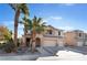 Two story house with a three car garage and mature palm trees at 6916 Snow Finch St, North Las Vegas, NV 89084