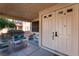 Covered porch with seating area and double front doors at 6916 Snow Finch St, North Las Vegas, NV 89084