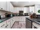 Kitchen with granite countertops, white cabinets, and ample counter space at 6916 Snow Finch St, North Las Vegas, NV 89084