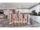 Kitchen island with seating and granite countertops at 6916 Snow Finch St, North Las Vegas, NV 89084