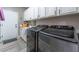 Laundry room with white cabinets and modern appliances at 6916 Snow Finch St, North Las Vegas, NV 89084