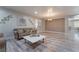 Spacious living room with wood-look floors, sofa, and coffee table at 6916 Snow Finch St, North Las Vegas, NV 89084