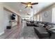 Spacious living room with hardwood floors, large sectional sofa, and open floor plan at 6916 Snow Finch St, North Las Vegas, NV 89084