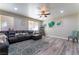 Living room with L-shaped sectional sofa and teal accents at 6916 Snow Finch St, North Las Vegas, NV 89084