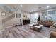 Living room with hardwood floors, staircase, and comfortable seating at 6916 Snow Finch St, North Las Vegas, NV 89084