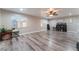 Bright loft with hardwood floors, ceiling fan, and built-in shelving at 6916 Snow Finch St, North Las Vegas, NV 89084