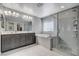 Modern bathroom with double vanity, soaking tub, and walk-in shower at 710 Bamboo Bend Pl, Henderson, NV 89011