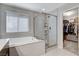Spa-like bathroom with soaking tub, walk-in shower, and large closet at 710 Bamboo Bend Pl, Henderson, NV 89011