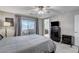 Bright bedroom with ensuite bathroom access, ceiling fan and private balcony at 710 Bamboo Bend Pl, Henderson, NV 89011
