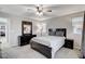 Spacious bedroom with dresser, ceiling fan, and ensuite bathroom access at 710 Bamboo Bend Pl, Henderson, NV 89011