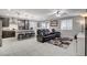Open concept kitchen with island, stainless steel appliances, and dark cabinets at 710 Bamboo Bend Pl, Henderson, NV 89011