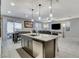Open concept kitchen and Gathering room with an island and stainless steel appliances at 710 Bamboo Bend Pl, Henderson, NV 89011