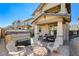 Backyard patio with hot tub, fire pit, and seating area at 710 Bamboo Bend Pl, Henderson, NV 89011