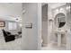 Convenient half bathroom with pedestal sink and round mirror at 710 Bamboo Bend Pl, Henderson, NV 89011