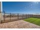 Artificial turf backyard with string lights and fence at 7206 Liberty Landing St, Las Vegas, NV 89166