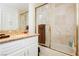 Bathroom with granite vanity, white cabinets, and a shower/tub combo at 7943 Harbour Towne Ave, Las Vegas, NV 89113
