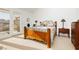 Spacious bedroom with wood bed frame and private door to balcony at 7943 Harbour Towne Ave, Las Vegas, NV 89113