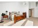 Bright bedroom with wood bed frame and access to a bathroom at 7943 Harbour Towne Ave, Las Vegas, NV 89113
