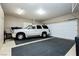 Well-lit garage featuring a car, rubber floor, and a clean, organized space at 7943 Harbour Towne Ave, Las Vegas, NV 89113