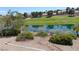 Panoramic view of a scenic golf course pond with houses in the background at 7943 Harbour Towne Ave, Las Vegas, NV 89113