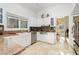 White kitchen features granite countertops and stainless steel appliances at 7943 Harbour Towne Ave, Las Vegas, NV 89113