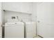 Laundry room with washer, dryer, and overhead cabinets at 7943 Harbour Towne Ave, Las Vegas, NV 89113