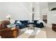 Open living room with sectional sofa and large windows at 7943 Harbour Towne Ave, Las Vegas, NV 89113
