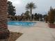 Beautiful community pool featuring lounge chairs, cabanas, and mature landscaping at 7943 Harbour Towne Ave, Las Vegas, NV 89113