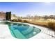 Curved pool with surrounding patio and lush landscaping at 7943 Harbour Towne Ave, Las Vegas, NV 89113