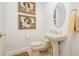Stylish powder room with pedestal sink, toilet, and framed art at 7943 Harbour Towne Ave, Las Vegas, NV 89113