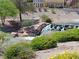 Picturesque water feature with rock accents surrounded by lush greenery and plants near a gorgeous home at 7943 Harbour Towne Ave, Las Vegas, NV 89113
