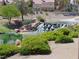 Scenic water feature with a flowing waterfall, lush plants, and a home in the background at 7943 Harbour Towne Ave, Las Vegas, NV 89113