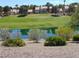 Water view of a pond reflecting the sky, with houses and a golf course in the background at 7943 Harbour Towne Ave, Las Vegas, NV 89113