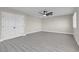 Spacious bedroom with ceiling fan and grey vinyl flooring at 8232 Ocean Terrace Way, Las Vegas, NV 89128