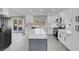 Modern kitchen with white cabinets, gray island, and quartz countertops at 8232 Ocean Terrace Way, Las Vegas, NV 89128