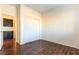 Bedroom with dark wood floors and mirrored closet doors at 824 Clear Diamond Ave, Las Vegas, NV 89123