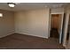 Spacious bedroom with brown carpet and hallway access at 10264 Headrick Dr, Las Vegas, NV 89166