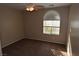 Inviting bedroom featuring plush carpeting, ceiling fan, and a window offering natural light at 10264 Headrick Dr, Las Vegas, NV 89166