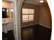 Bright bedroom with dark hardwood floors and access to bathroom at 10264 Headrick Dr, Las Vegas, NV 89166