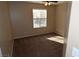 Cozy bedroom with plush carpeting, ceiling fan, and a window offering natural light at 10264 Headrick Dr, Las Vegas, NV 89166