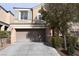 Charming two-story home featuring a two car garage and neutral colored stucco exterior at 10264 Headrick Dr, Las Vegas, NV 89166