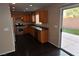 Kitchen featuring stainless steel appliances, wood cabinets, and a view to backyard at 10264 Headrick Dr, Las Vegas, NV 89166